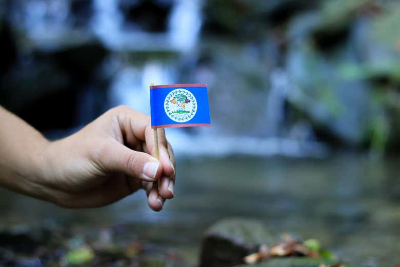 Belize flag next to the Mayan King waterfalls - Belize flag next to the Mayan King waterfalls