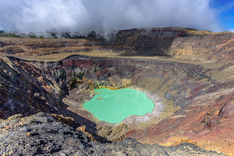 The crater and green lagoon of the volcano