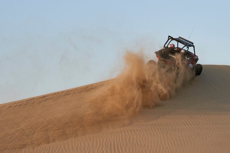 Surfing over the sand in a dune buggy