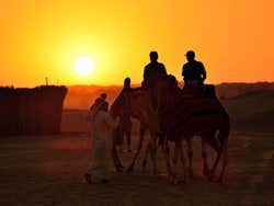 Taking a camel ride at sunset