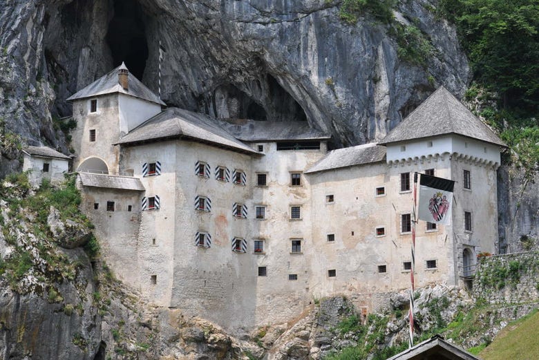 Predjama castle is built into the rock surface of a cliff