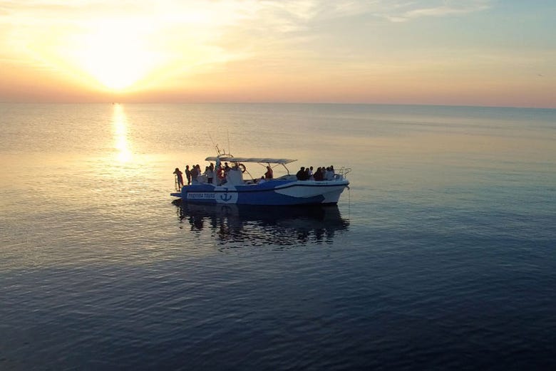 Sailing around Menorca at sunset