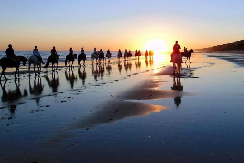 Horse riding on Doñana's beaches at sunset