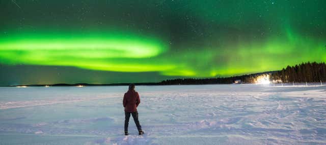 Paseo en moto de nieve bajo la aurora boreal