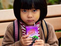 Niña bebiendo zumo en Hong Kong