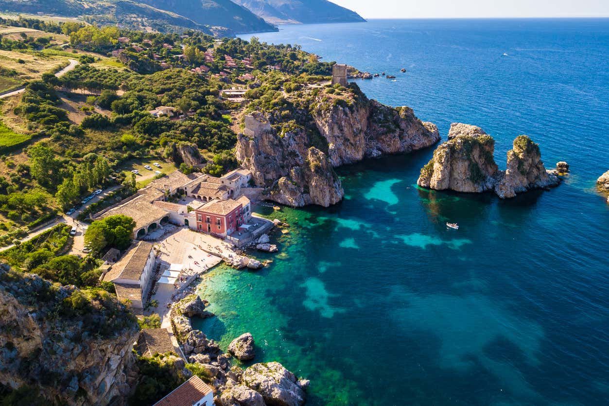 Tonnara di Scopello and its limestone sea stacks in turquoise water