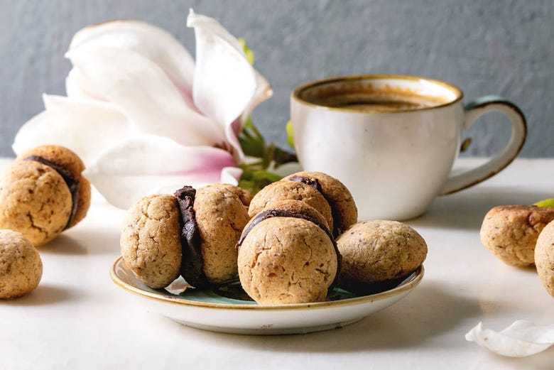 A coffee and baci di dama hazlenut cookies