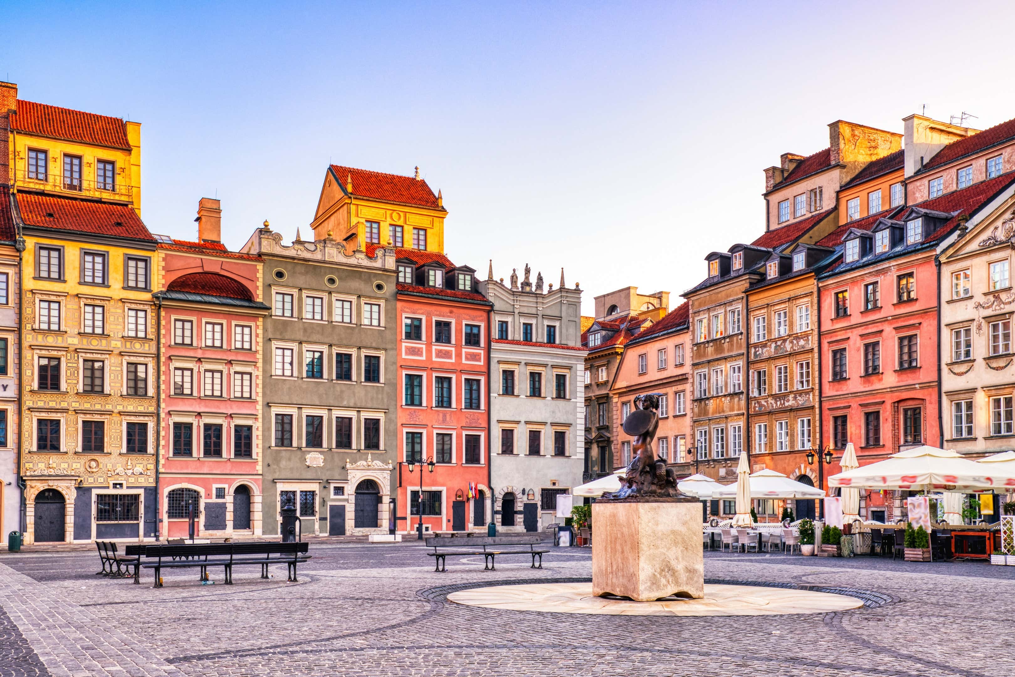 A shot of Warsaw with colorful buildings and a clear blue sky in the background.