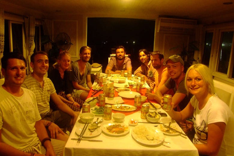 Grupo de turistas disfrutando de la cena vietnamita en el barco